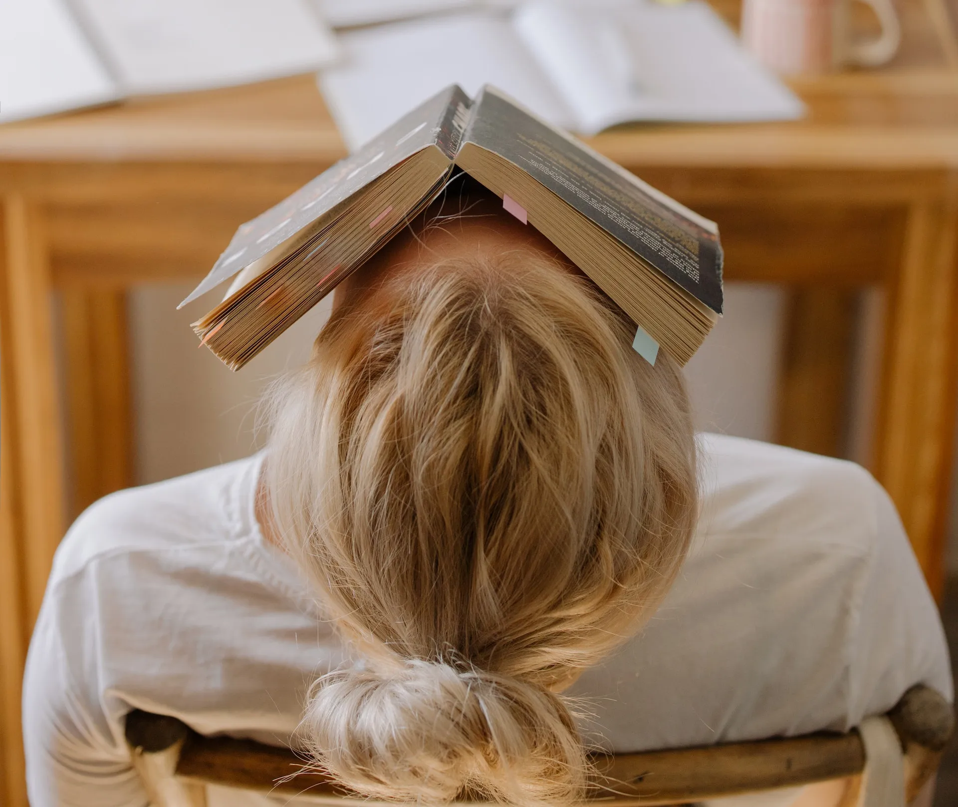 A student with a book on face