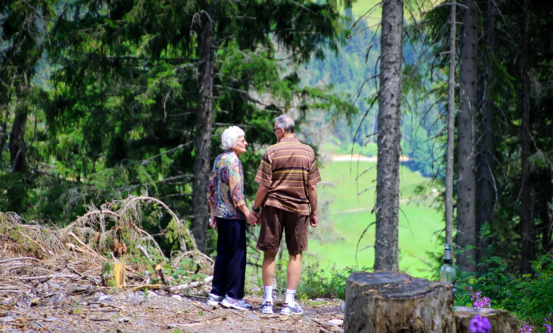 A man and woman taking a walk in the woods