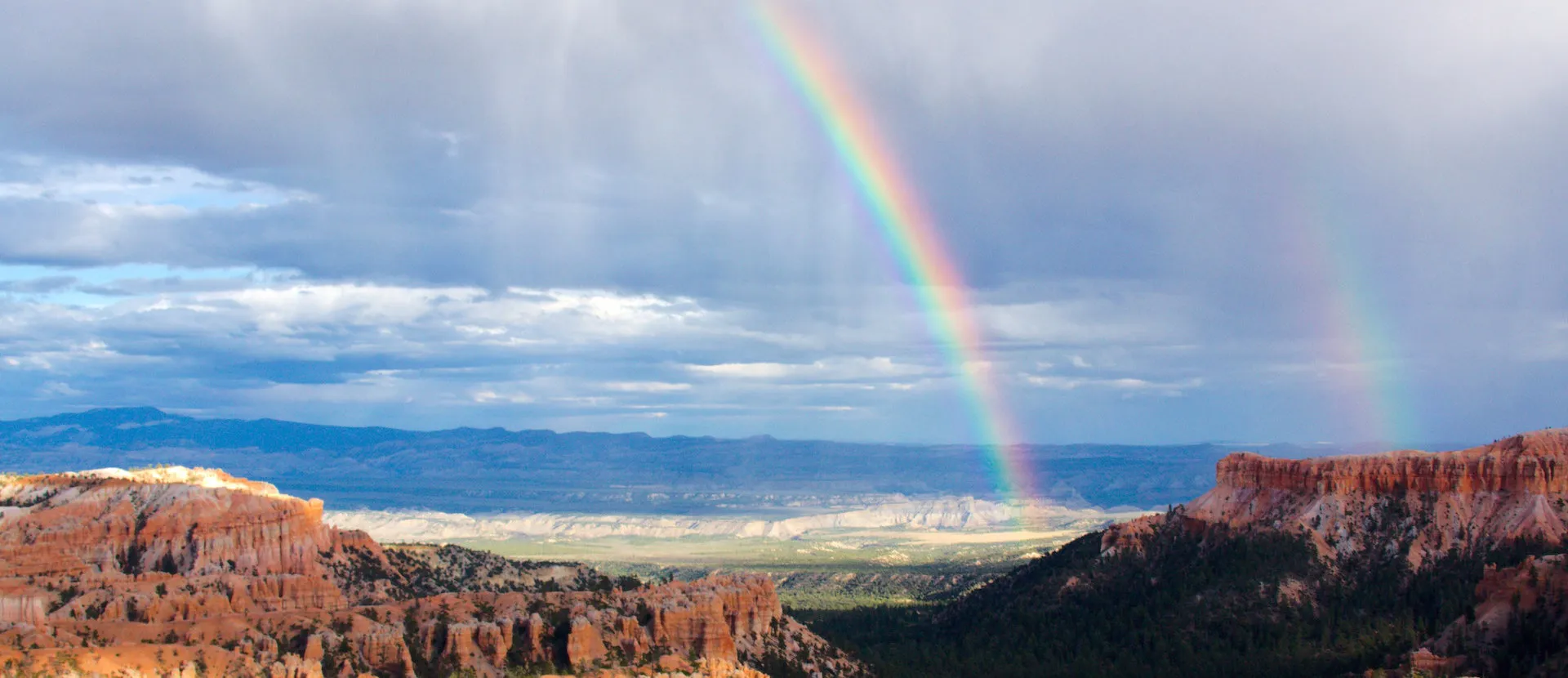 A rainbow over a desert canyon