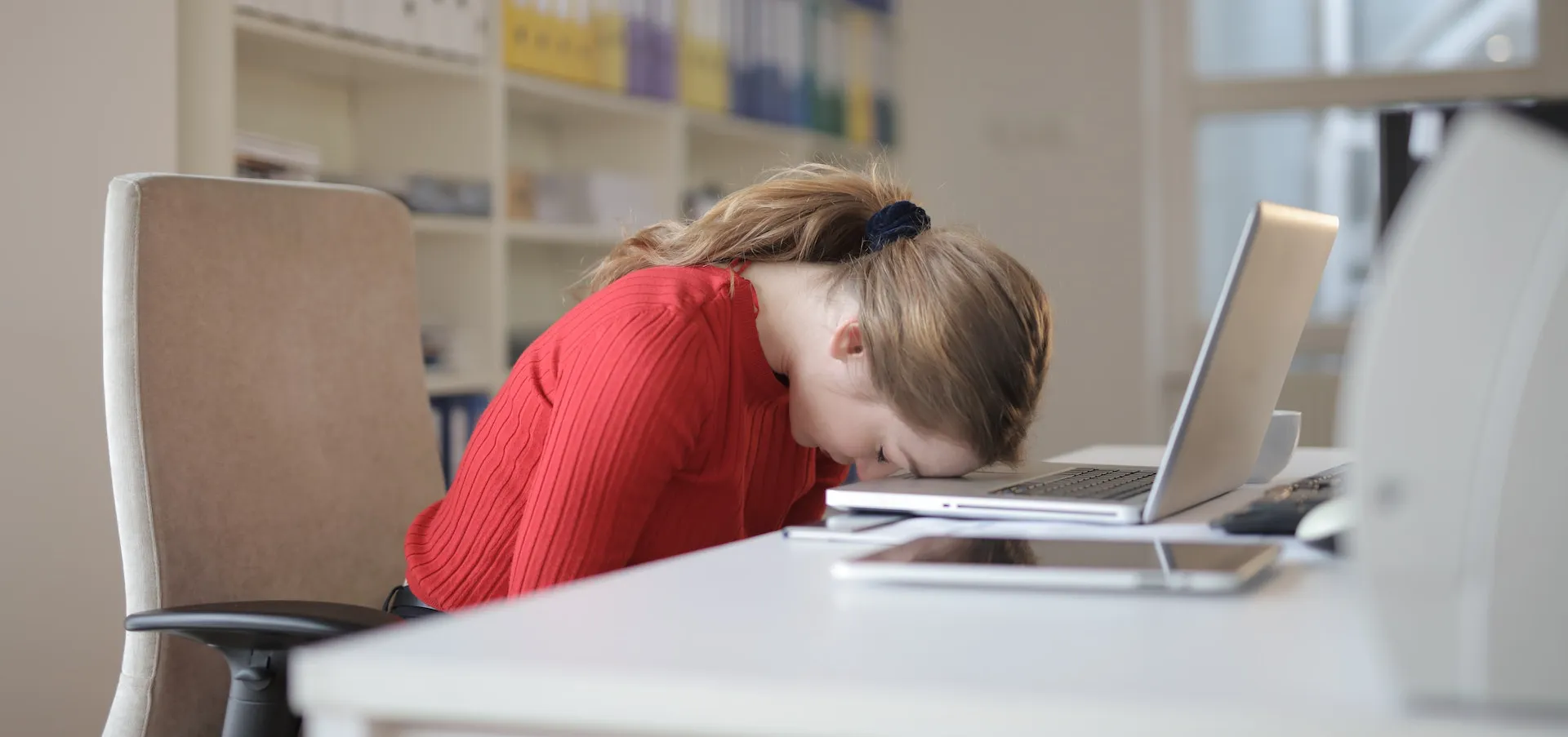 A student sleeping at her laptop